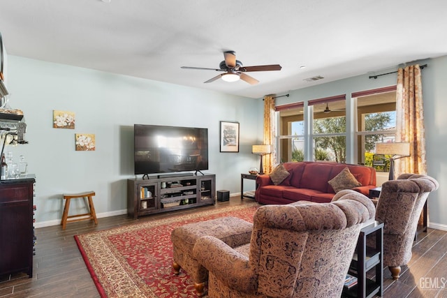 living room with ceiling fan and dark wood-type flooring