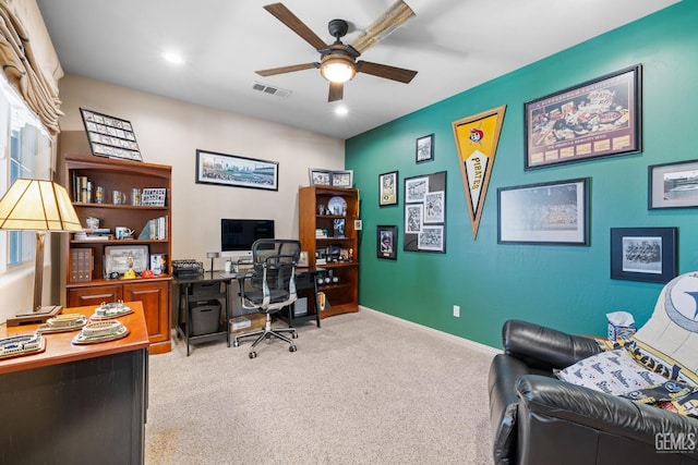 carpeted office space with ceiling fan