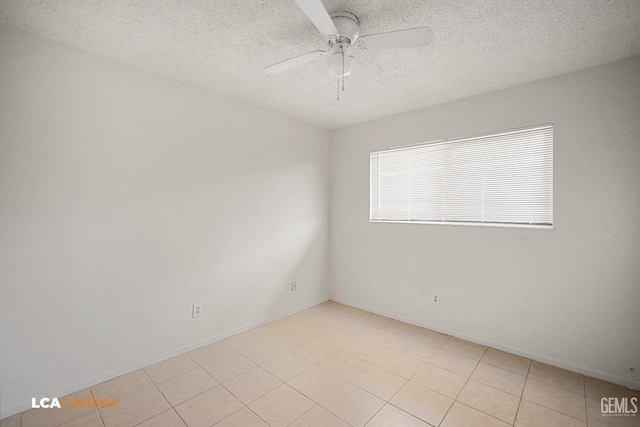 empty room with light tile patterned flooring, a textured ceiling, and ceiling fan