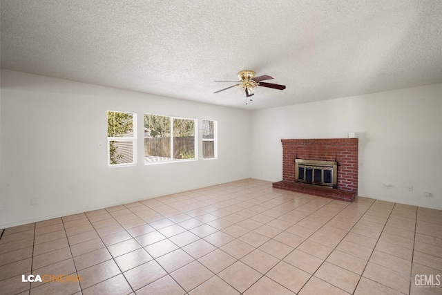 unfurnished living room featuring light tile patterned floors, a textured ceiling, a fireplace, and ceiling fan