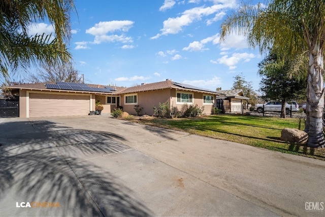 single story home featuring a garage, a front yard, and solar panels