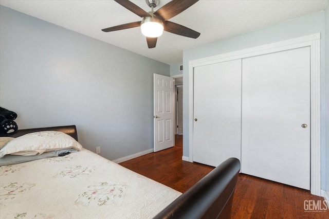 bedroom with wood finished floors, a closet, a ceiling fan, and baseboards