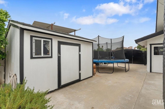 view of shed with a trampoline