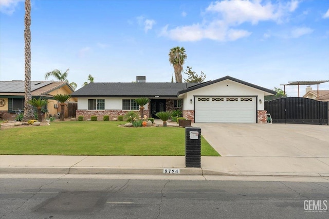 view of front of house with a gate, a front lawn, driveway, brick siding, and a garage