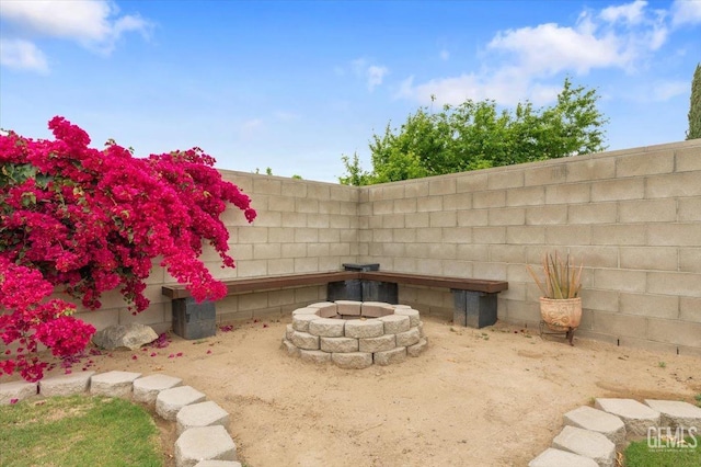 details featuring a fenced backyard and an outdoor fire pit