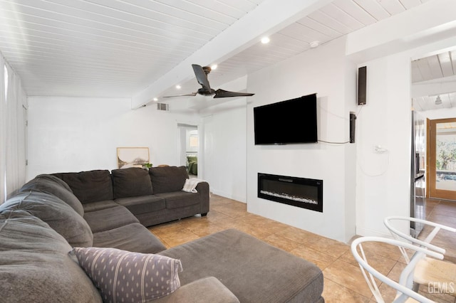909 Oberlin Ct, Bakersfield, CA 93305 - tiled living area with beamed ceiling, a ceiling fan, a glass covered fireplace, and recessed lighting