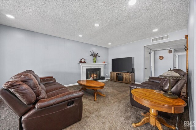 4418 Kevin Dr, Bakersfield, CA 93308 - carpeted living room featuring a fireplace, a textured ceiling, and recessed lighting
