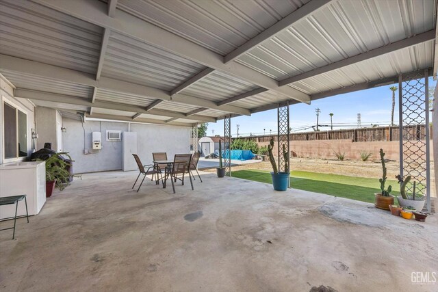 4418 Kevin Dr, Bakersfield, CA 93308 - view of patio with a shed, outdoor dining area, and a wall unit AC