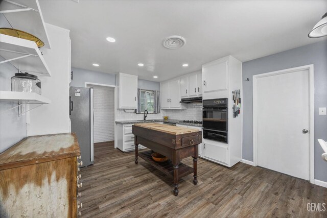 4418 Kevin Dr, Bakersfield, CA 93308 - kitchen with oven, open shelves, freestanding refrigerator, dark wood-style flooring, and white cabinetry