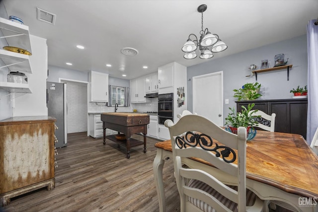 4418 Kevin Dr, Bakersfield, CA 93308 - dining space with a chandelier, dark wood-type flooring, and recessed lighting