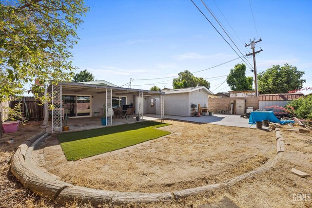 4418 Kevin Dr, Bakersfield, CA 93308 - back of house with a fenced backyard and a patio area