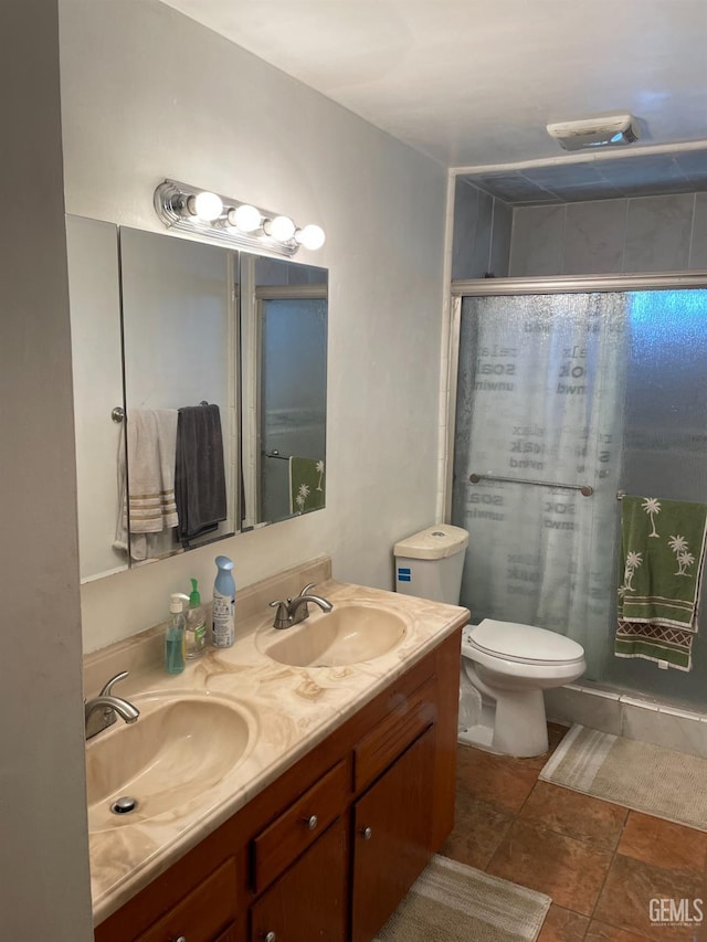 bathroom with toilet, a shower with door, and vanity