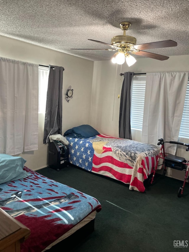 carpeted bedroom with a textured ceiling and ceiling fan