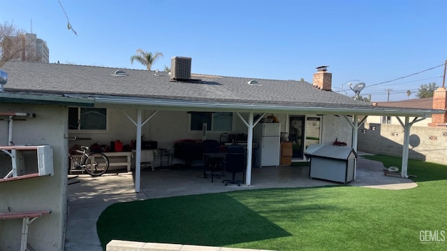 back of house featuring a patio area, a yard, and central AC unit