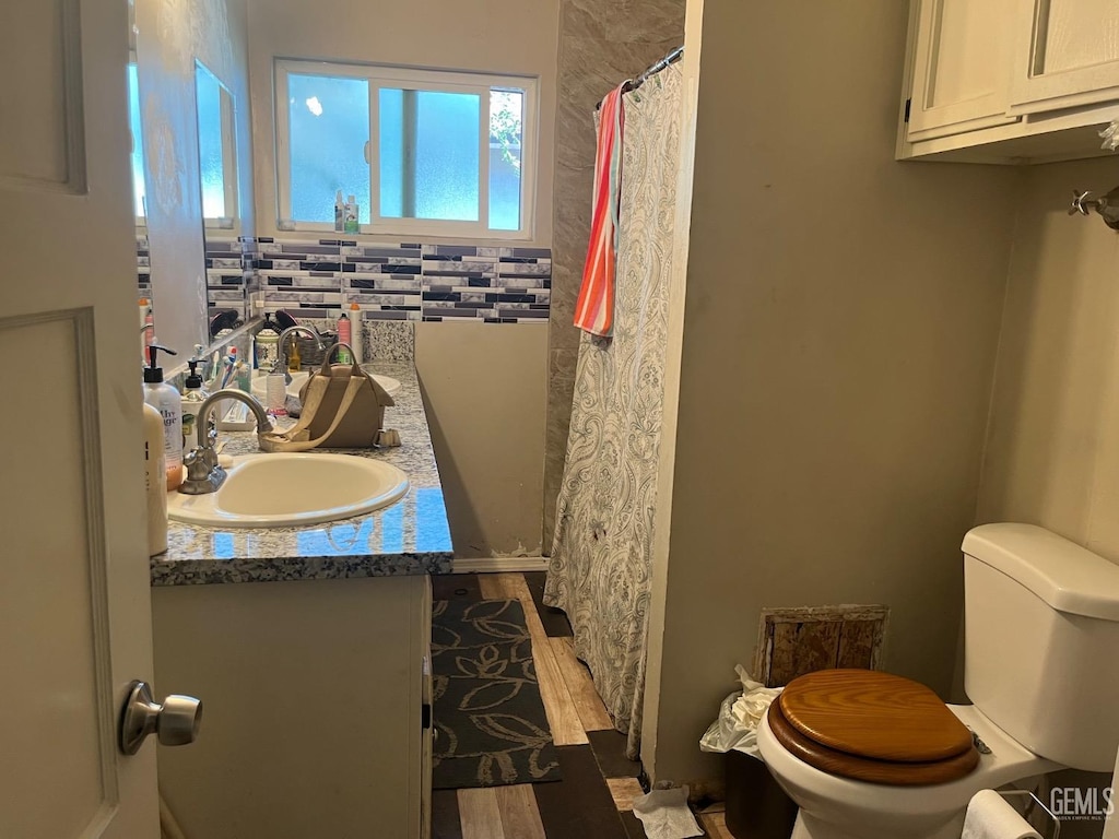 1112 Meredith Dr, Bakersfield, CA 93304 - bathroom featuring vanity, toilet, a shower with shower curtain, and wood finished floors
