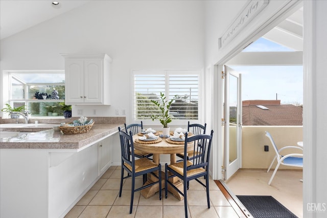 48 16th St, Cayucos, CA 93430 - dining room featuring plenty of natural light, light tile patterned flooring, and high vaulted ceiling