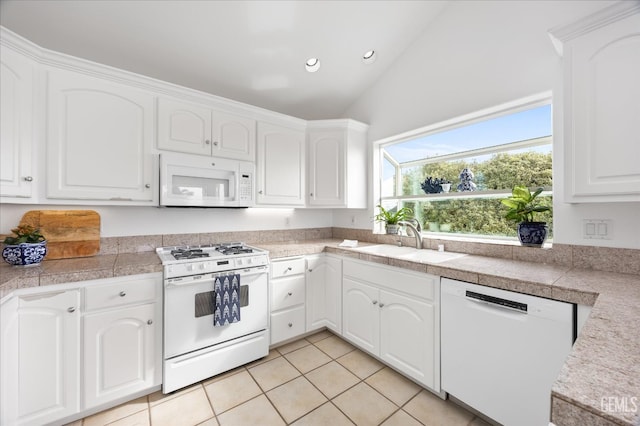 48 16th St, Cayucos, CA 93430 - kitchen with white appliances, tile countertops, recessed lighting, vaulted ceiling, and light tile patterned flooring