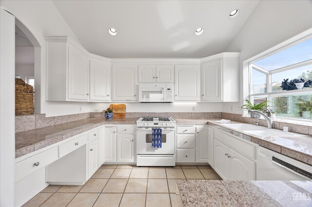 48 16th St, Cayucos, CA 93430 - kitchen featuring white appliances, tile countertops, light tile patterned floors, white cabinets, and arched walkways