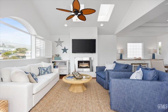 48 16th St, Cayucos, CA 93430 - living room with lofted ceiling, ceiling fan, a skylight, a glass covered fireplace, and recessed lighting