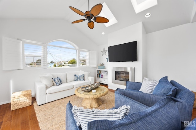 48 16th St, Cayucos, CA 93430 - living area with wood finished floors, a ceiling fan, lofted ceiling, a skylight, and a glass covered fireplace
