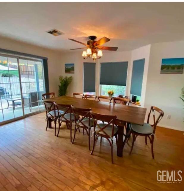 dining space with light hardwood / wood-style flooring and ceiling fan