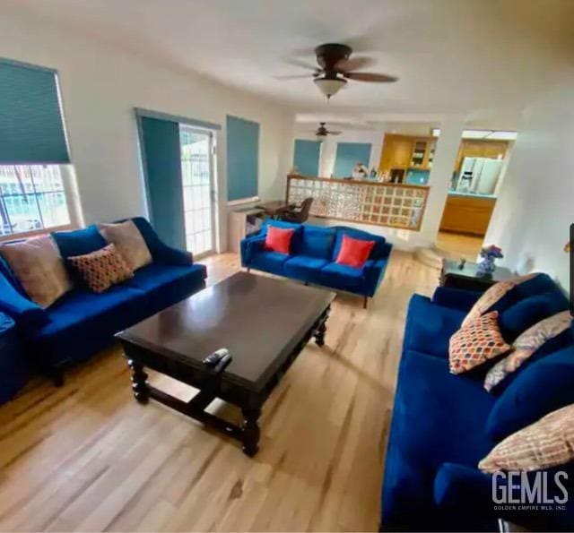 living room featuring hardwood / wood-style floors and ceiling fan