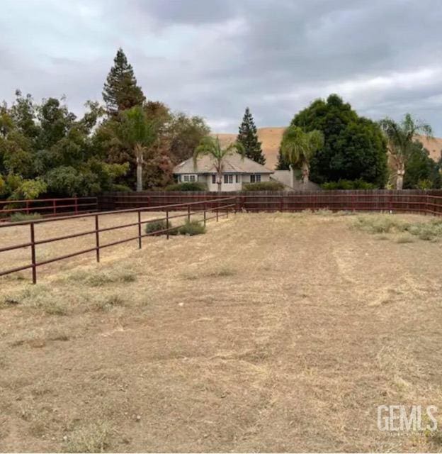 view of yard with a rural view