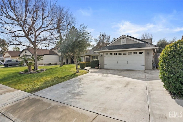 view of front of house with a garage, a front lawn, and concrete driveway