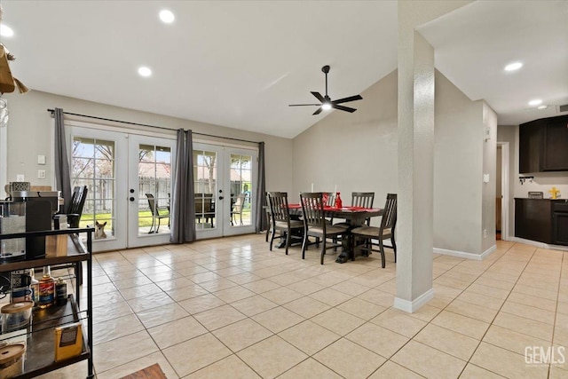 dining space with light tile patterned floors, baseboards, vaulted ceiling, and french doors