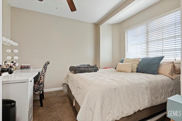 bedroom with dark colored carpet, ceiling fan, and baseboards