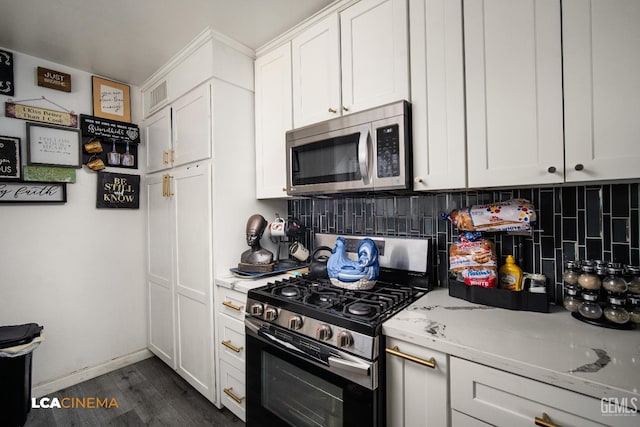 1102 Oleander Ave, Bakersfield, CA 93304 - kitchen with stainless steel appliances, backsplash, white cabinets, dark wood-style flooring, and light stone countertops