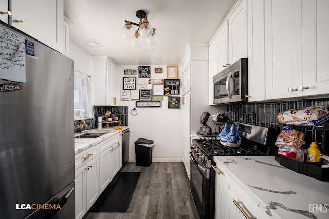 1102 Oleander Ave, Bakersfield, CA 93304 - kitchen with stainless steel appliances, tasteful backsplash, dark wood-style flooring, and white cabinetry