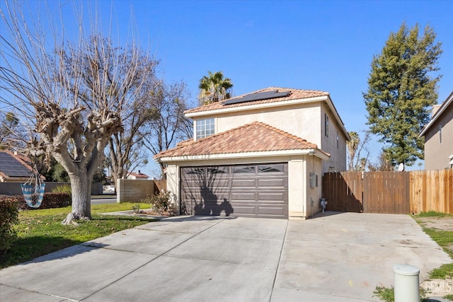 view of property exterior with a garage and solar panels