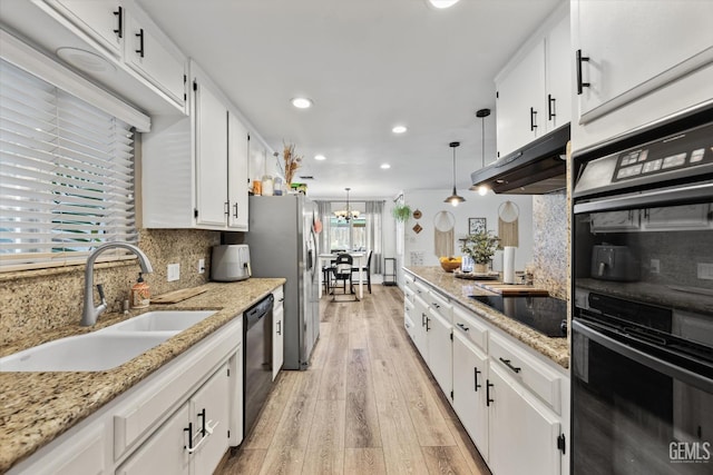 kitchen featuring decorative light fixtures, sink, white cabinets, black appliances, and light hardwood / wood-style flooring