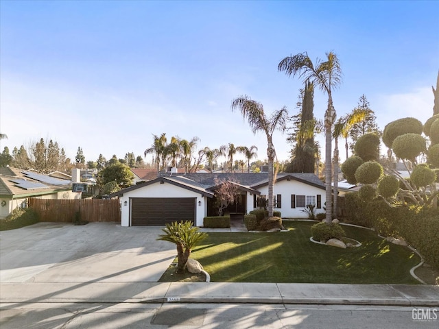 ranch-style house with a garage and a front yard