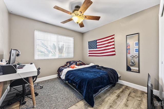 bedroom with ceiling fan and wood-type flooring