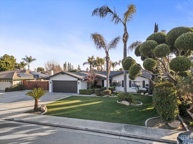 ranch-style home featuring a garage and a front yard