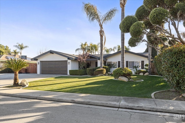 ranch-style home featuring a garage and a front yard