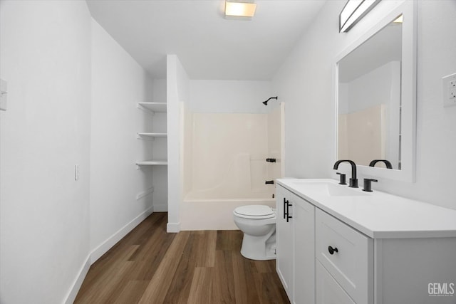 full bathroom featuring vanity, hardwood / wood-style flooring, bathing tub / shower combination, and toilet