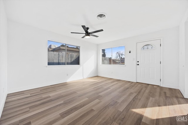 entryway with ceiling fan and light hardwood / wood-style flooring