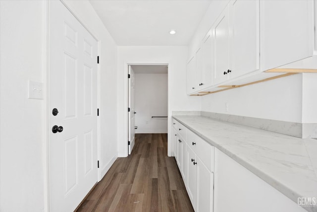 corridor with dark hardwood / wood-style flooring