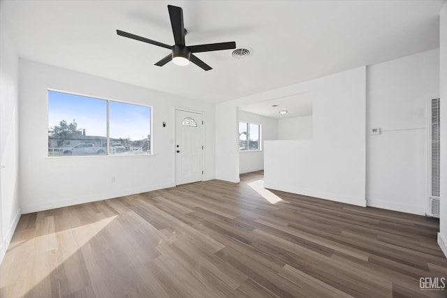 unfurnished living room featuring hardwood / wood-style floors and ceiling fan