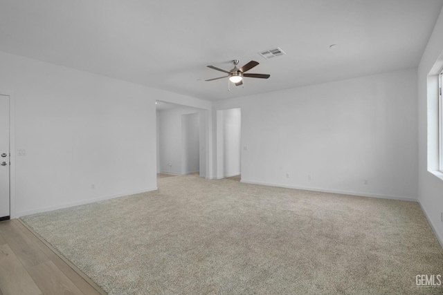 spare room featuring light hardwood / wood-style floors and ceiling fan