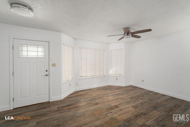 foyer featuring a textured ceiling, baseboards, and dark wood-style flooring