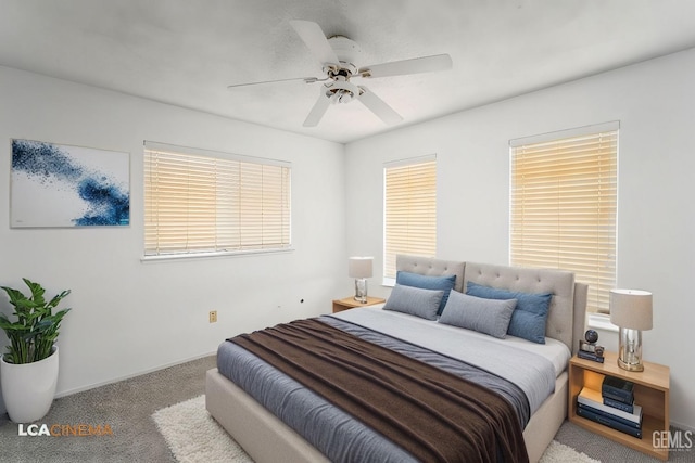 bedroom with multiple windows, a ceiling fan, and light colored carpet