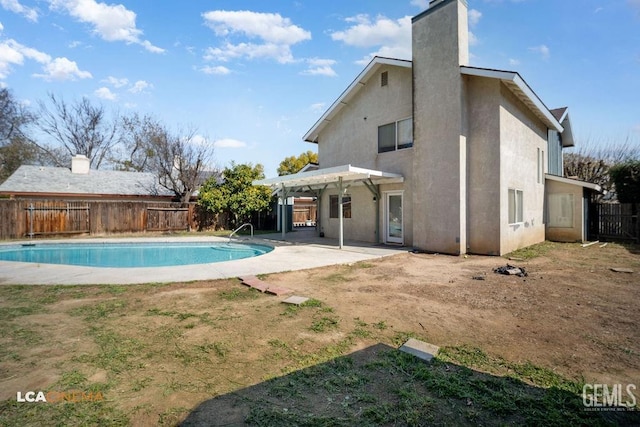 rear view of house featuring a fenced in pool, stucco siding, a patio area, a pergola, and a fenced backyard