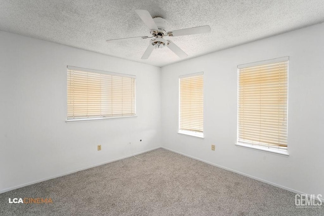 unfurnished room featuring a ceiling fan, carpet, a textured ceiling, and baseboards