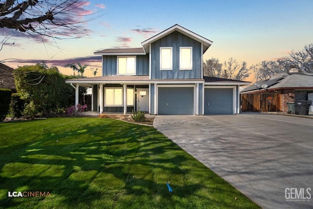 view of front facade featuring a porch, board and batten siding, a garage, driveway, and a front lawn