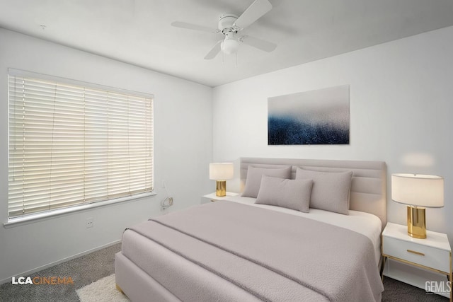 bedroom featuring ceiling fan and dark carpet