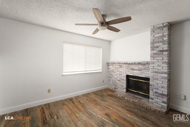 unfurnished living room featuring a brick fireplace, ceiling fan, baseboards, and dark wood-style flooring